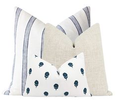 two pillows with blue flowers on them, one is white and the other is beige