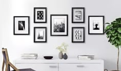 a white room with black and white pictures on the wall