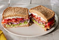 a cut in half sandwich sitting on top of a white plate