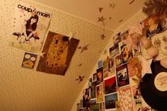 a wall covered in pictures and posters next to a record