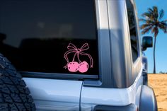 a pink sticker on the side of a car