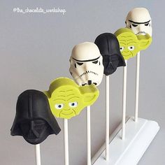 four star wars cake pops with faces on them in the shape of darth vader heads