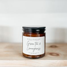 a glass jar filled with brown liquid on top of a wooden table