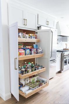 an organized pantry in the middle of a kitchen