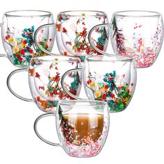 six glass coffee mugs filled with liquid and confetti sprinkles