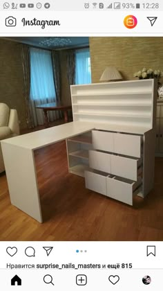 a white desk with drawers on top of it in the middle of a wooden floor