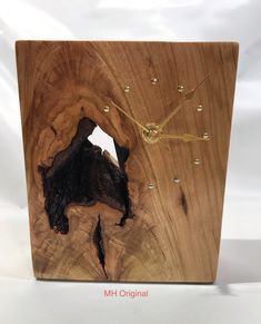 a wooden clock with a hole in the middle