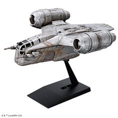 a silver model of a star trek ship on a black stand