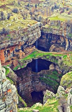 an aerial view of a cave in the mountains