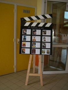 a black and white clapper board with pictures on it in front of a door