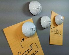 three golf balls on top of a piece of paper with the words golf written on it