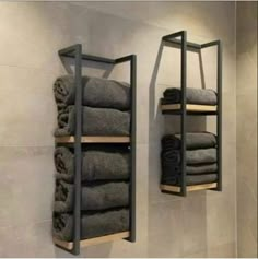 two shelves with towels hanging on them in a bathroom