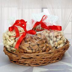 a basket filled with nuts and wrapped in red ribbon