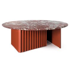 a round table with an orange metal base and white paint on the top, against a white background