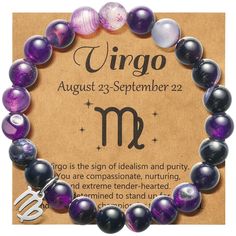 the zodiac sign for virgo is displayed in front of a brown card with purple and black beads