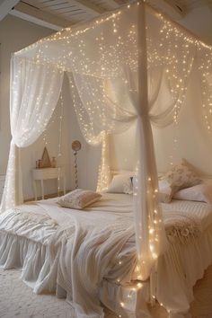 a white canopy bed with lights on it