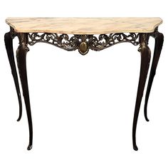 an antique console table with marble top