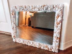 a large mirror sitting on top of a hard wood floor