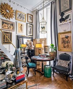 a living room filled with furniture and pictures on the wall