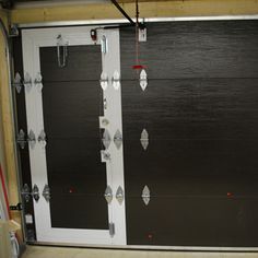 an overhead garage door with metal studs and screws on the bottom half of it