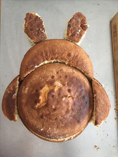 a cake shaped like an animal with ears on it's head and eyes made out of bread