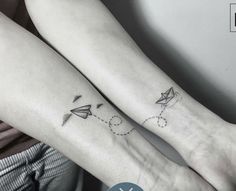 two people with matching tattoos on their arms