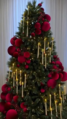 a christmas tree decorated with candles and ornaments