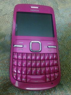 a pink nokia cell phone sitting on top of a table