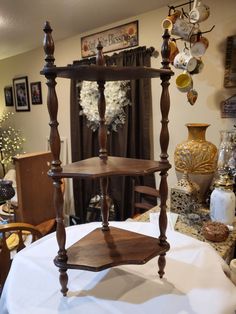 a wooden table with three tiered shelves on it