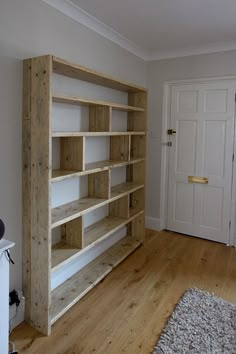 an empty room with wooden shelves in the middle and carpet on the floor next to it