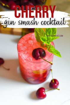 a cherry gin smash cocktail with fresh cherries on the rim