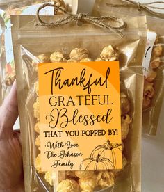 a hand holding a bag of popcorn that says, grateful grateful blessed that you popped by the pumpkin family