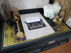 an old fashioned typewriter sitting on top of a book