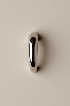 a white door handle on the wall