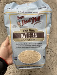 a hand holding a bag of oat bran