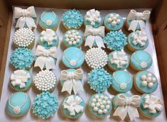 a box filled with blue and white decorated cupcakes