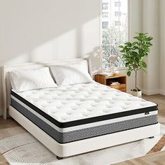 an image of a mattress that is in the middle of a room with white walls