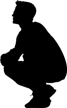 a silhouette of a man sitting on the ground