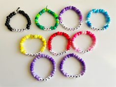 six different colored bracelets with the word love written on each beaded strander