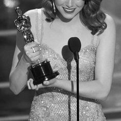 the actress is holding her oscar award for best supporting actress in a musical motion,