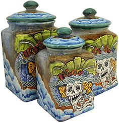 two ceramic jars with designs on them sitting next to each other in front of a white background