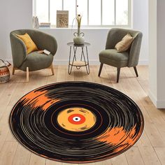 a living room with two chairs and a rug that has an image of a record on it