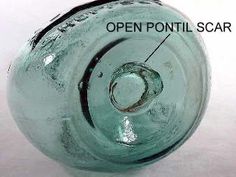 an old glass vase with the words open point scar on it's bottom side