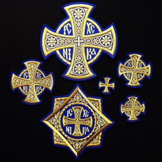 the cross is surrounded by other crosses on black background with blue and gold trimmings