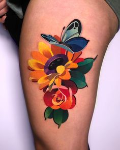 a woman's thigh with colorful flowers and butterflies on it