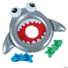 an inflatable shark balloon with three smaller plastic fish around it's mouth