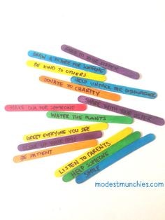 several colored plastic toothbrushes with writing on them