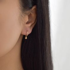 Sweet and dainty, these gold huggie earrings feature a polished round charm. Made of 14K gold filled materials, these earrings are tarnish-resistant, water-resistant, and hypoallergenic. Hoop measures 12mm in diameter while the charm measures 4mm in diameter. To put them on, don't pull the hoop apart, instead bend them towards opposite sides like shown in the photo. --------------------♥ PROMOS ♥-------------------- Want 10% off? Join the mailing list by visiting http://bit.ly/vedern . Just leav Delicate Teardrop Hoop Earrings As Gift, Delicate Teardrop Hoop Earrings For Gift, Delicate Hypoallergenic Small Hoop Earrings, Delicate Single Round Earring, Delicate Round Single Earring, Delicate Small Hoop Earrings With Ear Wire, Huggie Plug Earrings As Gift, Delicate Drop Huggie Earrings As Gift, Small Hoop Pearl Earrings For Gift