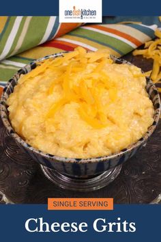 a bowl filled with cheese grits on top of a table