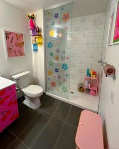 a bathroom with a toilet, sink and shower stall